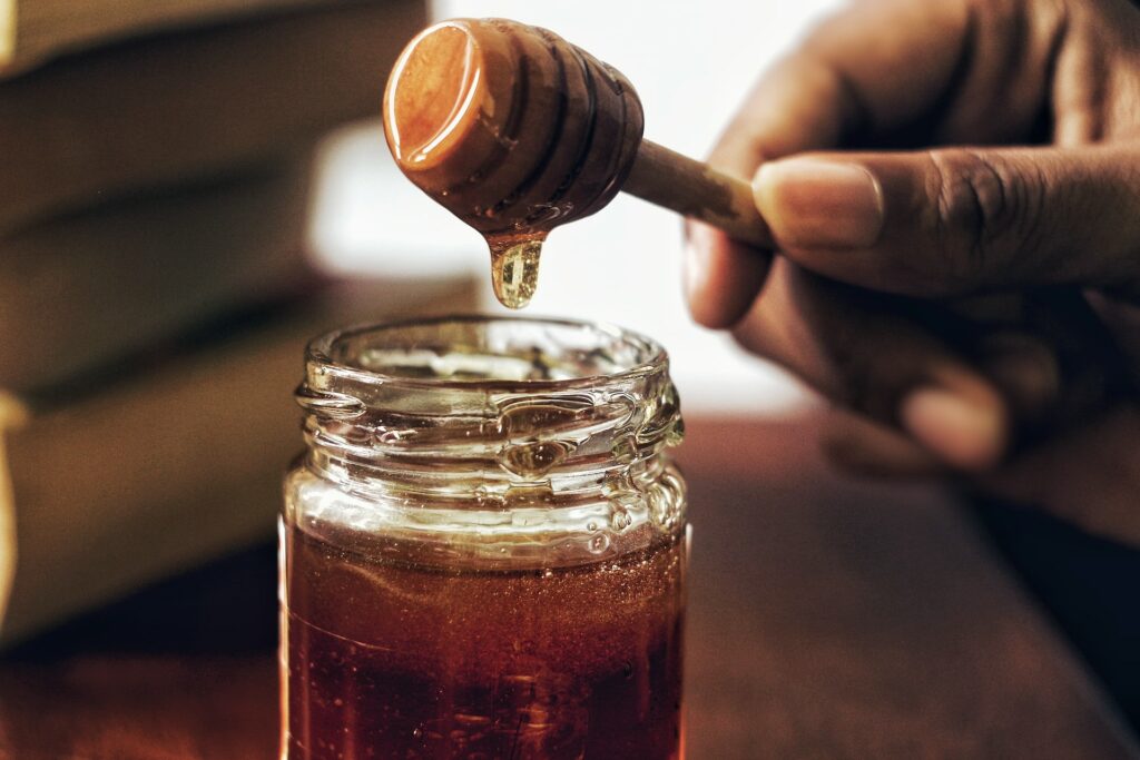 Honey jar with honey comb photo