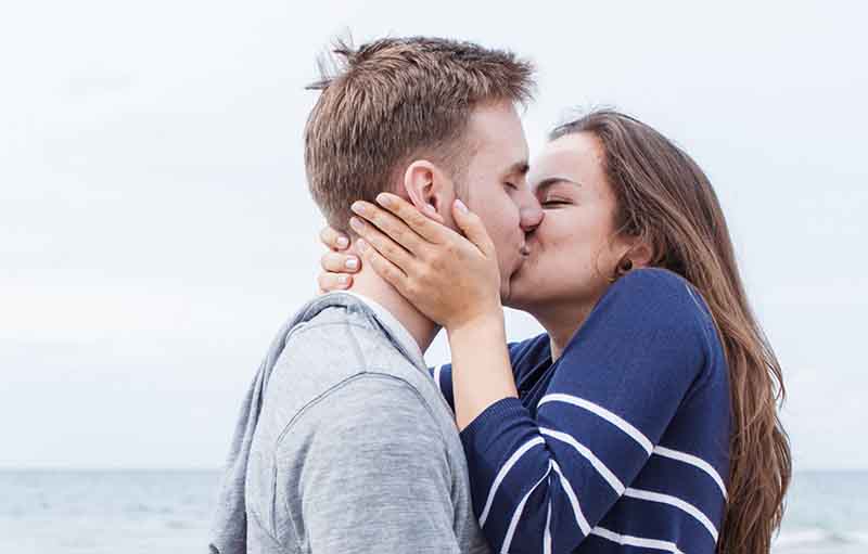 Woman and Man Kissing by the Beach