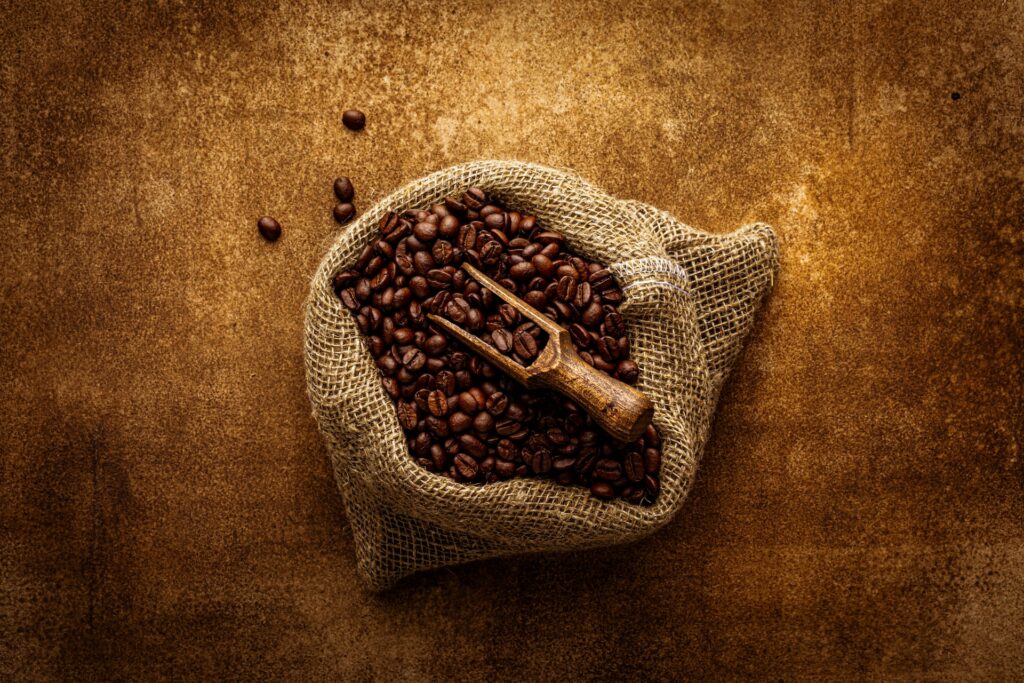 A sack filled with coffee beans and a scoop