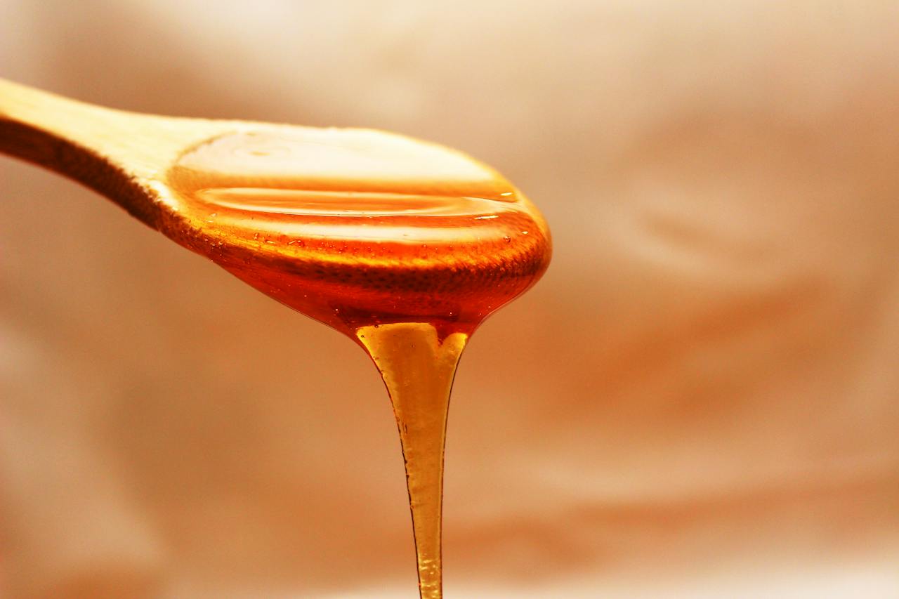 Brown Wooden Spoon With Honey Photo